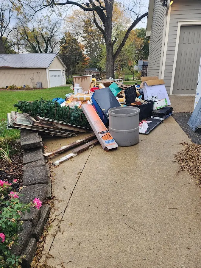 Dumpster being loaded with debris for Roofing Dumpster Rental in Upper Salford